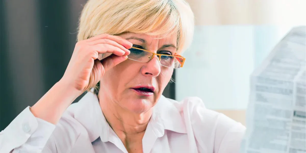 Person reading printed information with glasses lowered