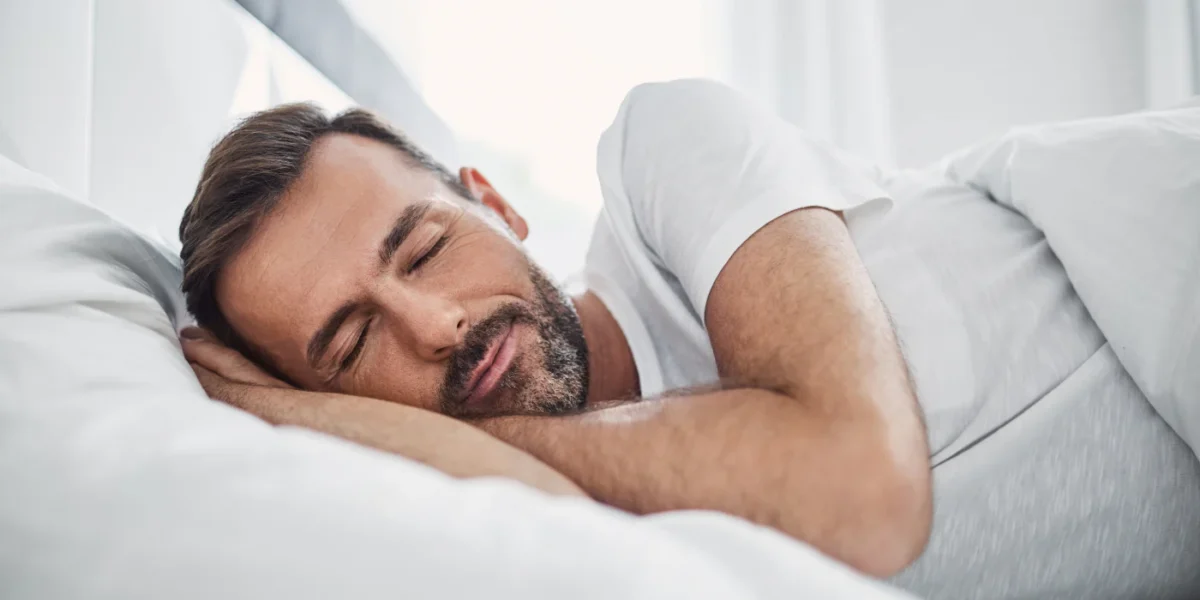 Person resting in bed in soft evening light